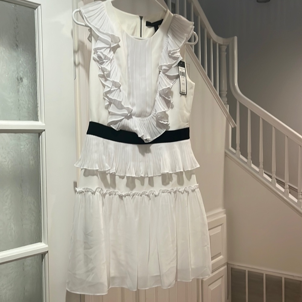 White chiffon dress with ruffle detail cut out back detail and black waist